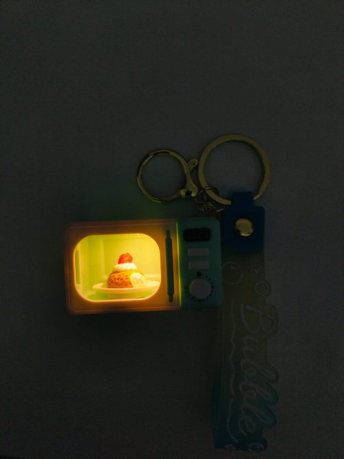 WhatsApp Image 2026-02-21 at 12.21.43 Mini Microwave Oven Keychain with LED Light and Realistic Sound Effects
